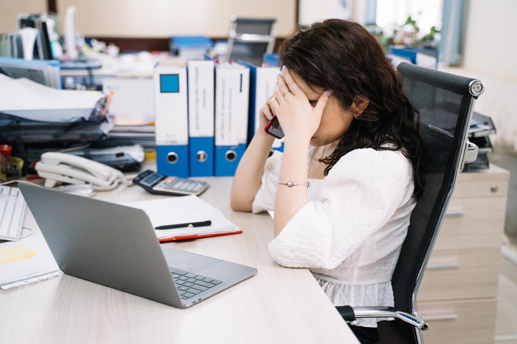 Femme stressée par un appel professionnel et ayant besoin de poser une limite au travail